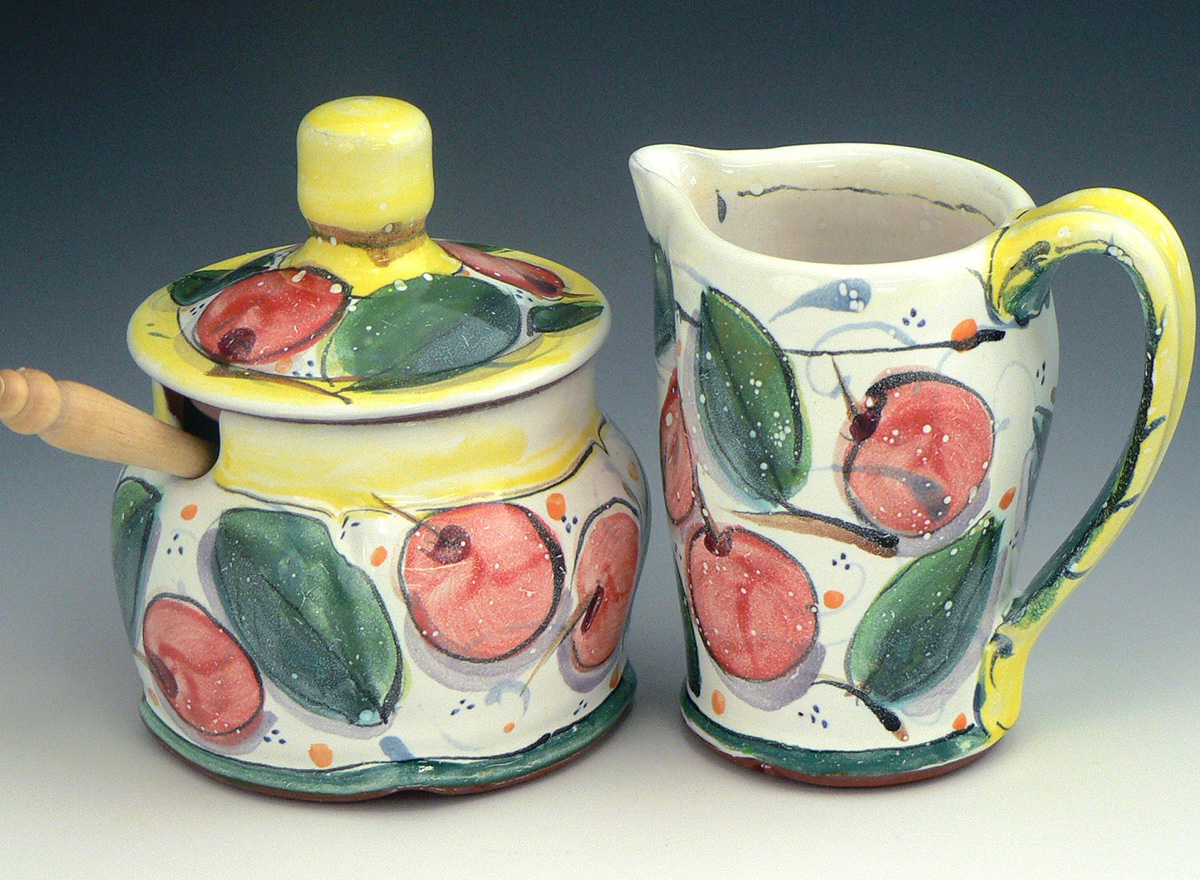Colorful pottery with designs of apples and leaves 