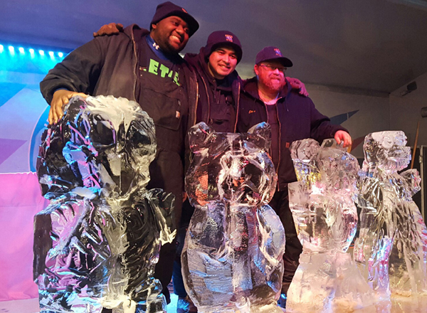HFC Ice Carving Club Members Robert Speeks, Jeff Lao and Steve McCormick pose with their sculptures created during the dueling chainsaws segment of competition. 