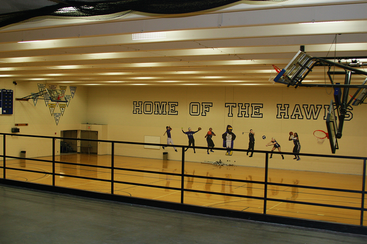 Elevated view of gymnasium, with basketball hoop now in view