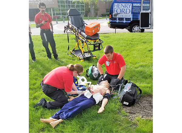 HFC students perform a simulated 911 call with a high-tech patient simulator on campus grounds
