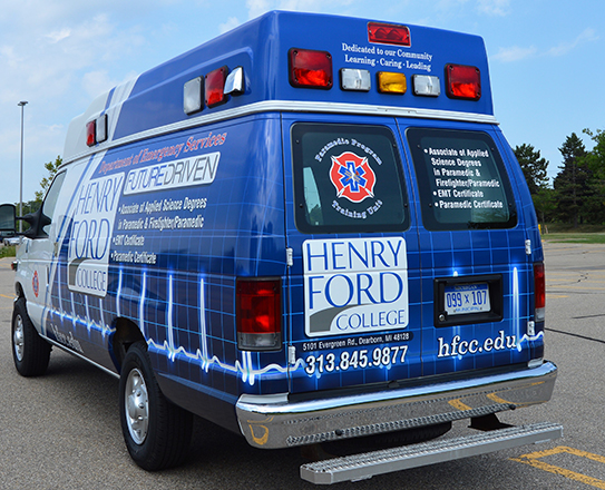 The rear and sides of the ambulance list the EMS programs available at HFC.