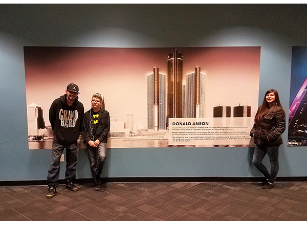 Don Anson's three children stand in front of his award-winning photo of the Renaissance Center, located on the first floor of Tower 100. 