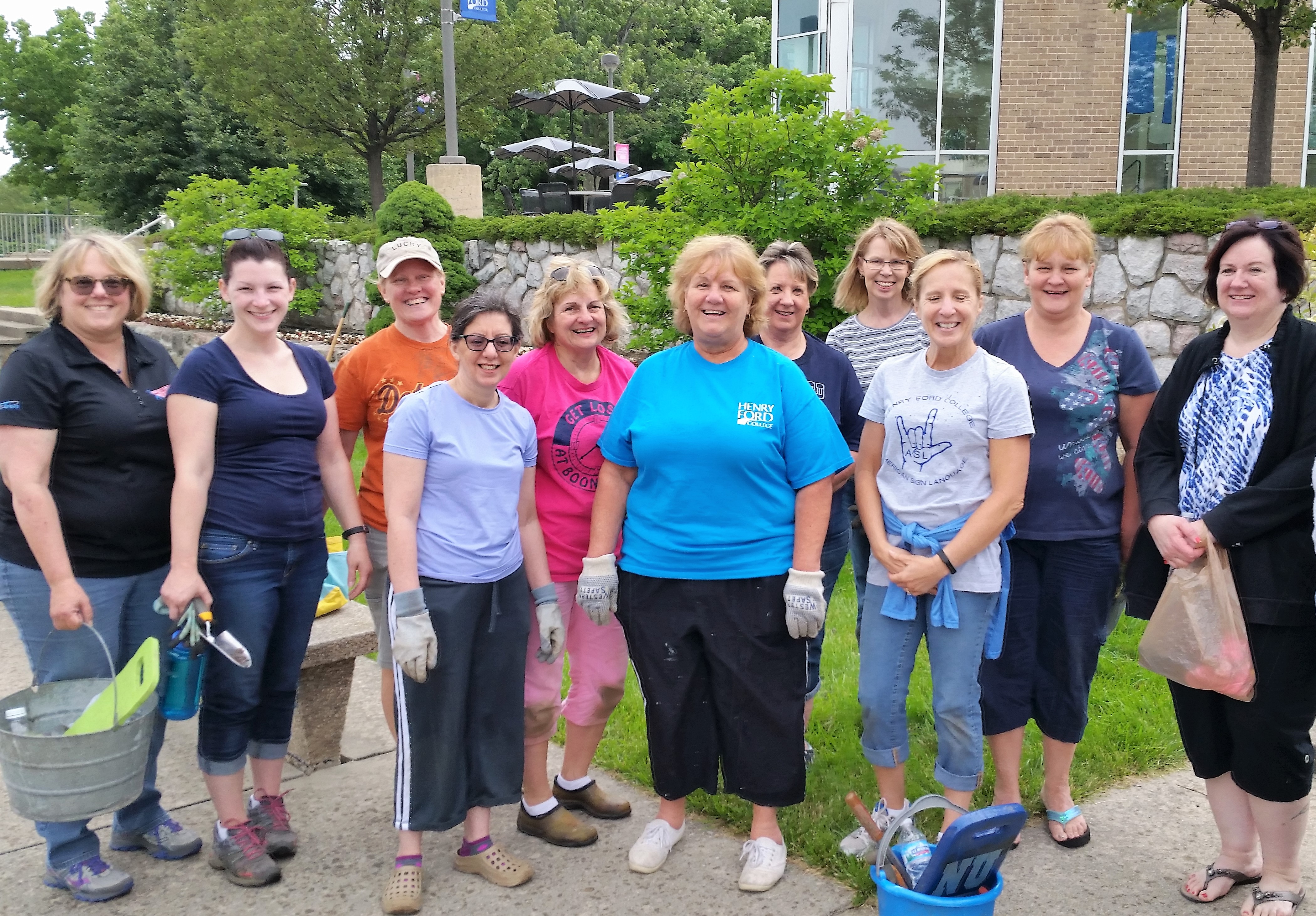 Eleven HFC employees ready for gardening. Notice how they're all women. Come on, guys, join in the fun!