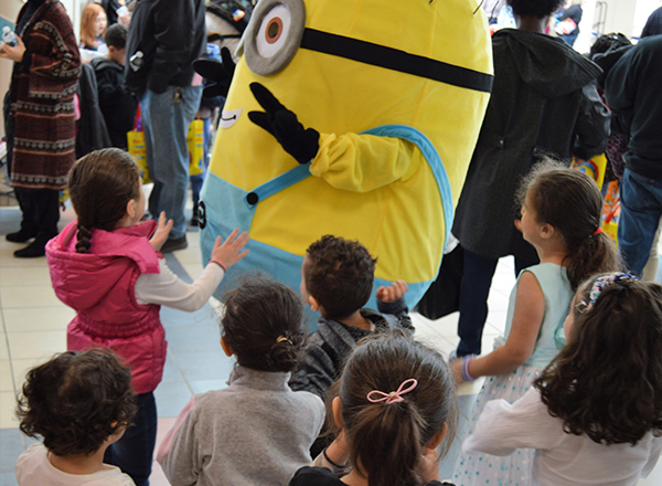 Children play with a life-sized Minion