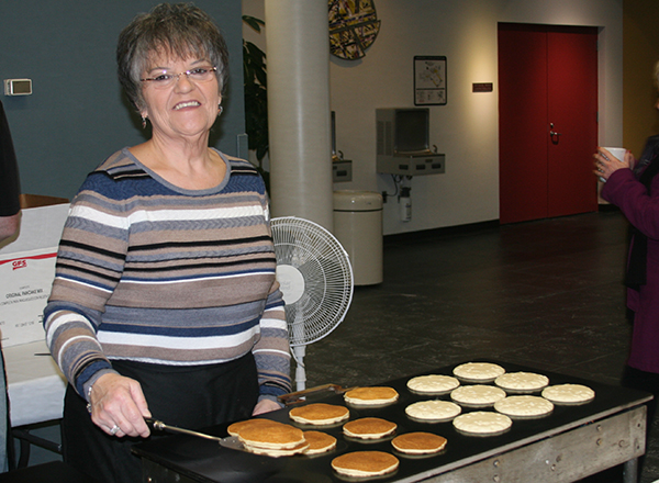 Woman serving pancakes