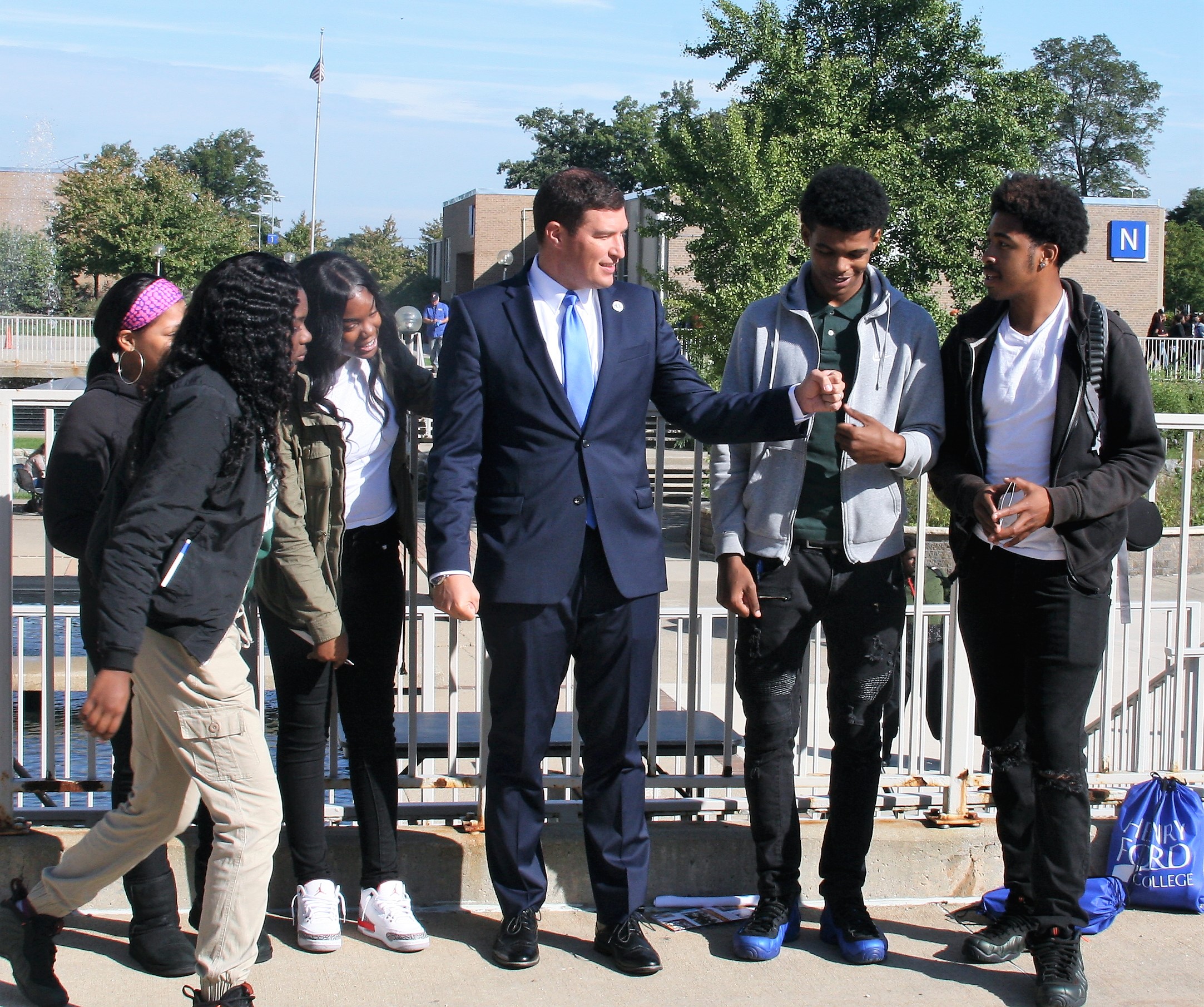 Students from Cody High School in Detroit hang around with President Russell Kavalhuna at Discover Day. 