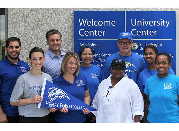 A group of HFC Enrollment Services employees smiling, showing off their HFC spirit