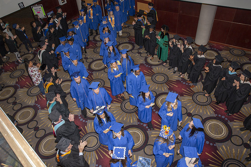 graduates head toward the theater