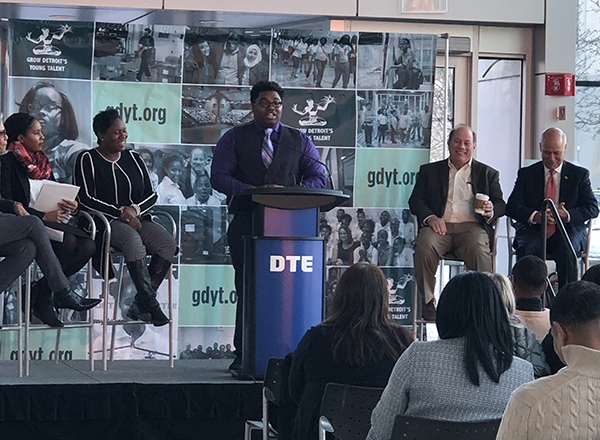 Tyrone Bean presents at the DTE headquarters, flanked by Mayor Mike Duggan (second from right) and other leaders.