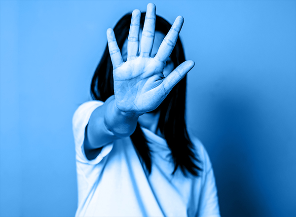 Photo of woman holding her hand out in front of her face