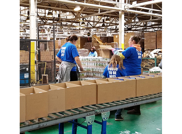 Volunteers pack food for the needy at Focus: HOPE's central warehouse in Detroit. 
