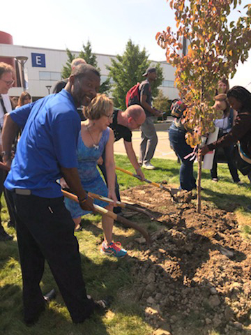 A group of students, faculty, and staff helped plant a tree during the Climate Forum. 