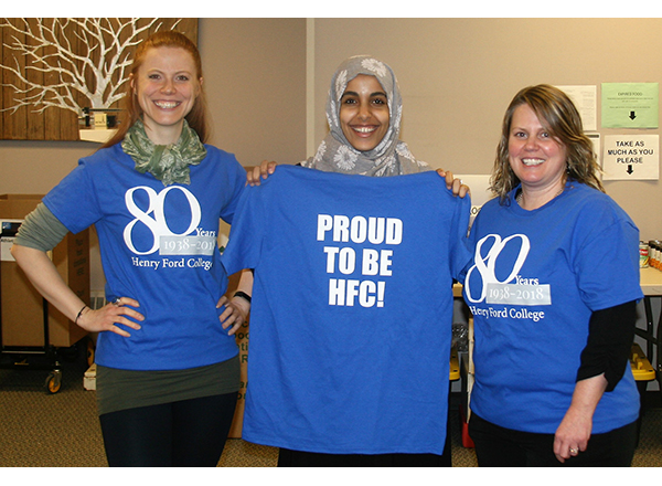 3 women wearing the HFC 80th Anniversary tees 