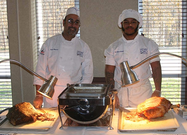 photo of 2 culinary students at their food stations 