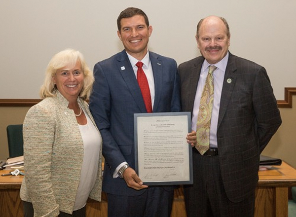 EMU Regent Mary Treder Lang and EMU President James Smith present the resolution to HFC President Russell Kavalhuna.