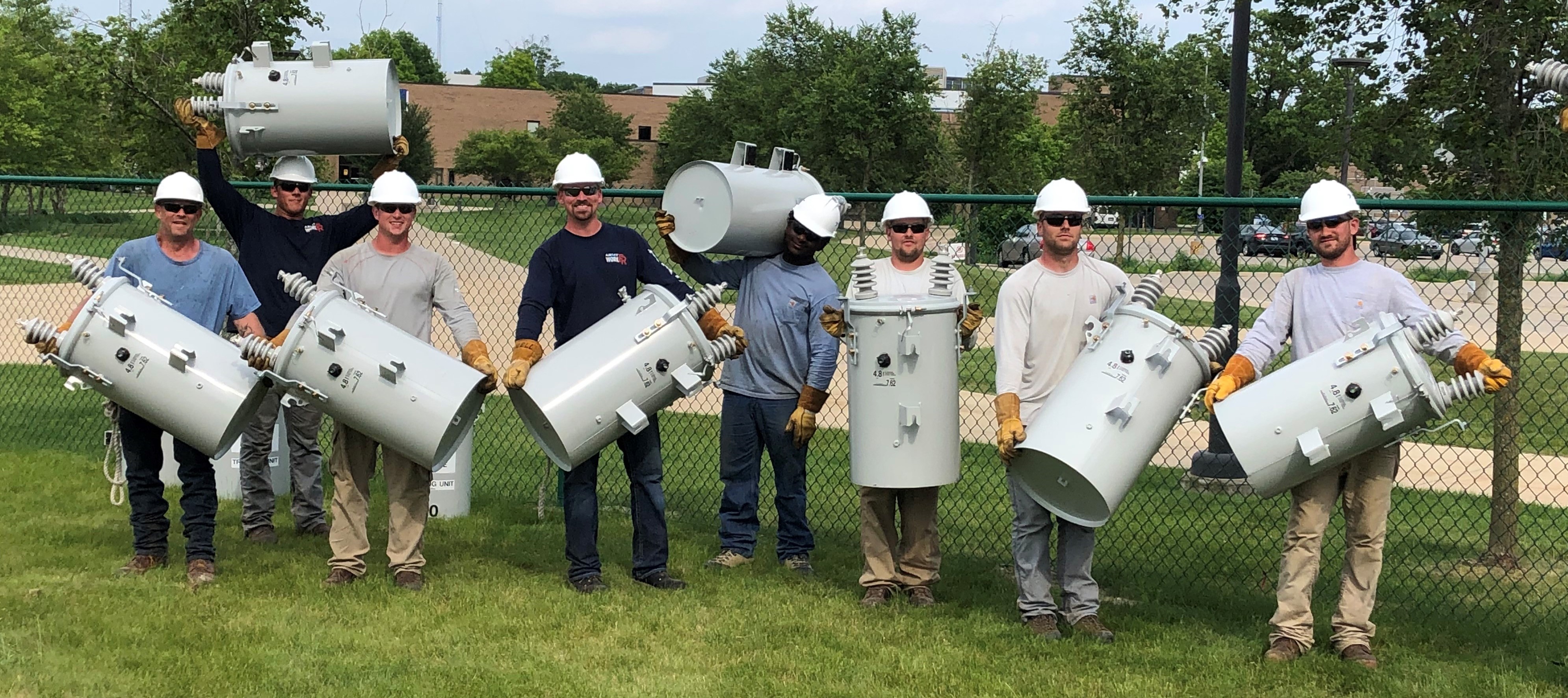 DTE workers show their muscle by lifting transformers. HFC is using oil-free transformers due to EPA regulations and the close proximity of the Rouge River. 