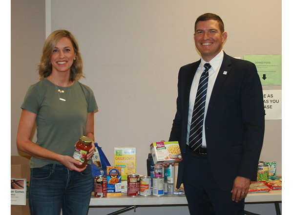 President Russell Kavalhuna and his wife Courtney contributed food items and toiletries to the recent food drive. 