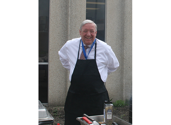HFC Vice President of Finance, Facilities, IT, and Auxiliary Services John Satkowski happily trades in his suit jacket for an apron. 