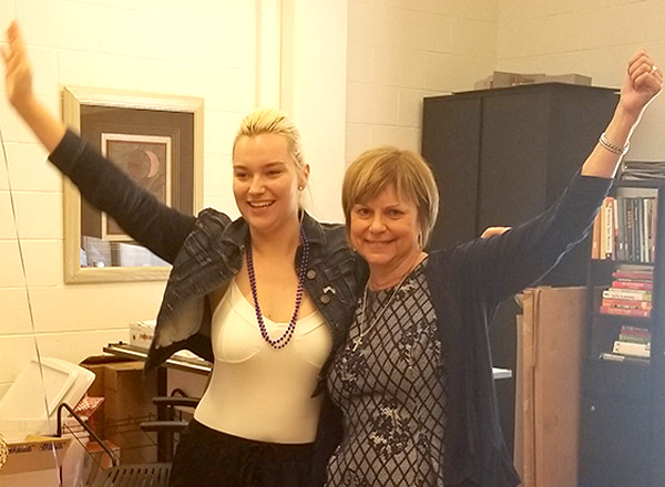 HFC alumna Allison Jones (left) and HFC Interior Design program coordinator Karen Wilmering (right) pump their arms in victory after learning Jones won 2nd place in the NKBA Student Design Competition.