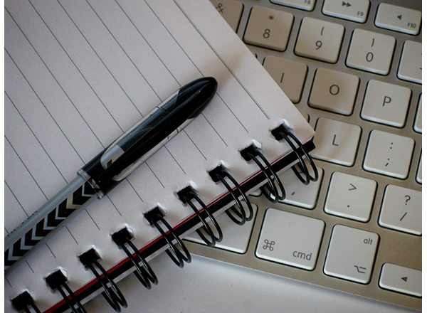 Graphic of a pen, notebook, and keyboard