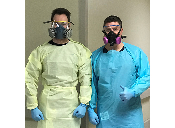 Family values: HFC nursing alumni Ryan Moore (left, son of HFC Nursing Chair Trina Moore) and David Shunkwiler (right, son of HHS Dean Susan Shunkwiler) in full medical gear to combat the COVID-19 pandemic.