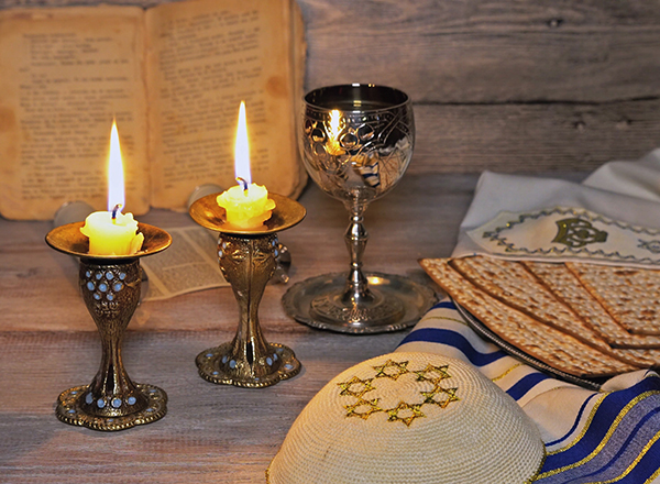 Candles, wine cup, Haggadah, matzah, other emblems of Passover