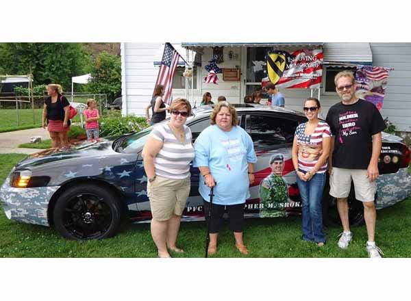 The family of the late PFC Christopher Sroka stand in front of the 2004 Grand Prix GTP that his father Mark restored to honor him. From left to right are Sroka's sister Lauren, mother Theresa, sister Samantha, and father Mark. 