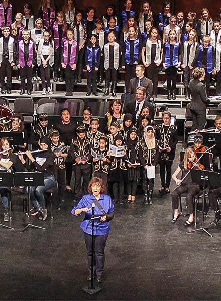 Lisa Meyer leads the combined orchestras and choirs at the Youth Arts Festival at the Ford Community and Performing Arts Center. 