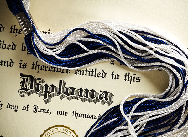 An image of a diploma and a tassel. 