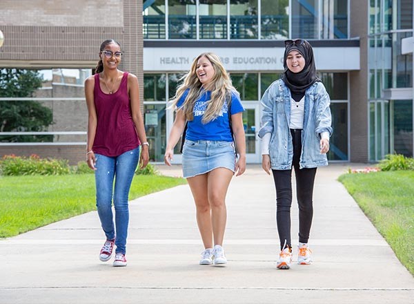 Professional photographer Lance Rosol's work has led him back to HFC. He took the picture of these three students in front of the School of Health & Human Services. 