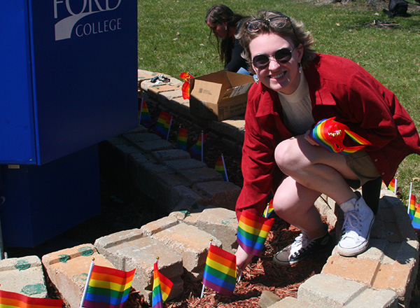 HFC student Autumn Sternberg installing a pride flag.