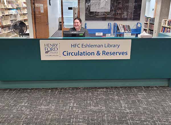 HFC User Librarian Tessa Betts works at the circulation desk. 