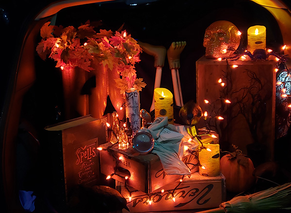 A Trunk or Treat car lit up at night.