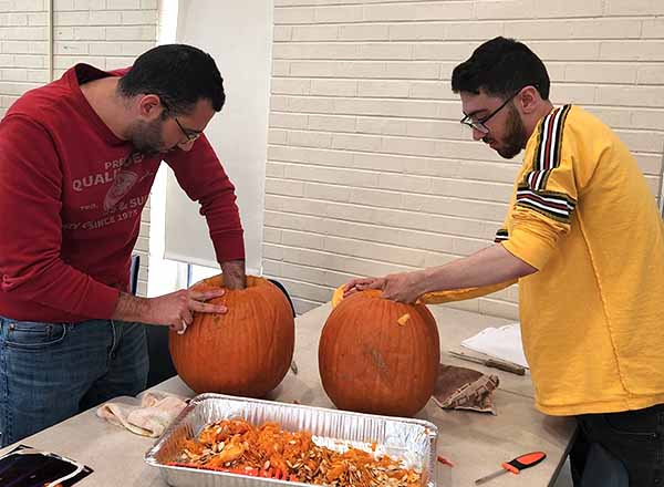 From L-R: Harout Ichkhanian and Ramey Abdole carve their pumpkins. 