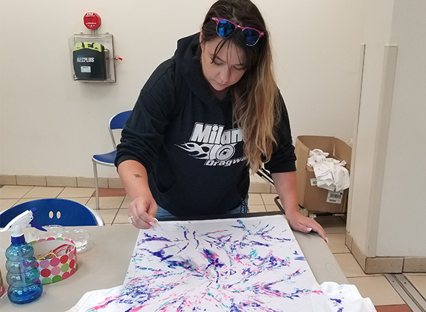 An HFC student tie-dyes a T-shirt. 