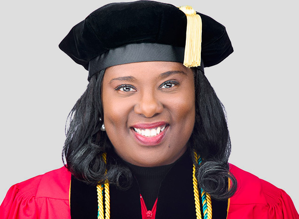 A head shot of Dr. Shai James-Boyd in her cap and gown.