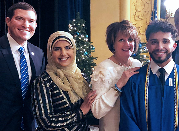 Ibrahim Saleh (far right), son of HFC Assistant Director, Student Conduct and Compliance and Title IX Coordinator Munira Kassim, graduated from HFC, earning his associate degree in nursing in 2019. From L-R: HFC President Russell Kavalhuna, Kassim, Dean 