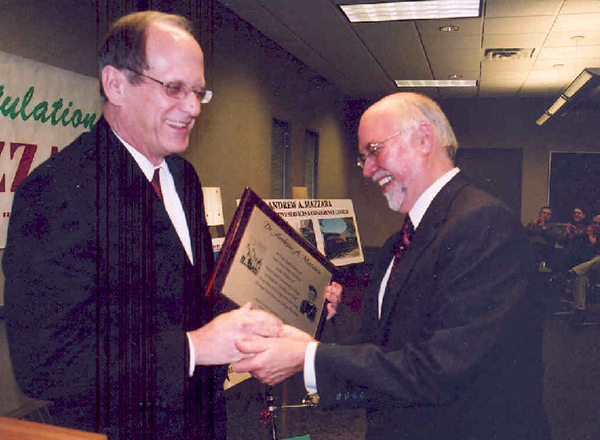From L-R: John McDonald presents HFC President Emeritus Dr. Andy Mazzara with an award for his years of service to the College circa 2005. 