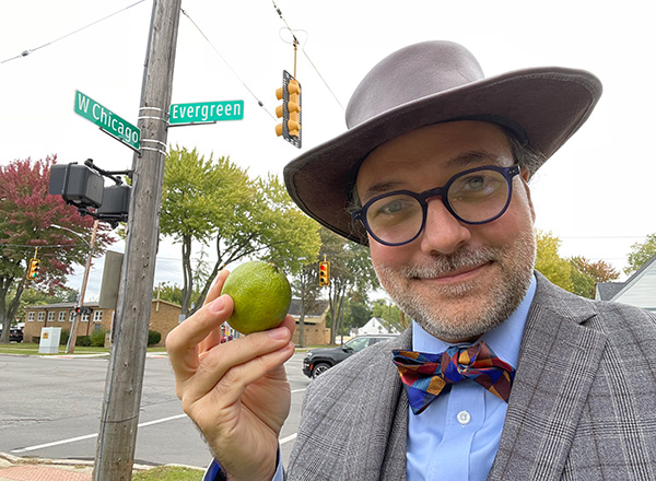 Jesse Mason holds up a lime that is a stand-in for Uranus on West Chicago. 