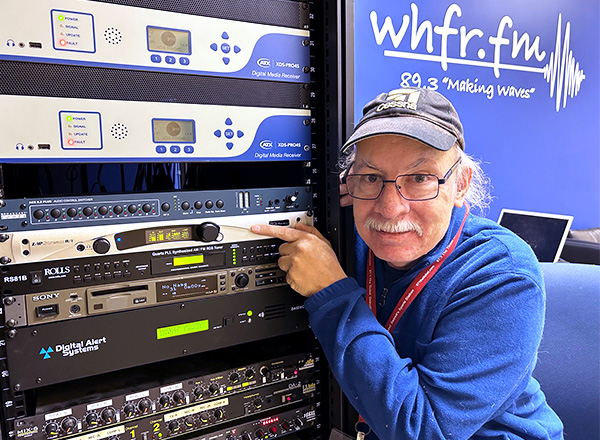 Bob Burnham points to the new improved sound equipment used for streaming inside the WHFR station.