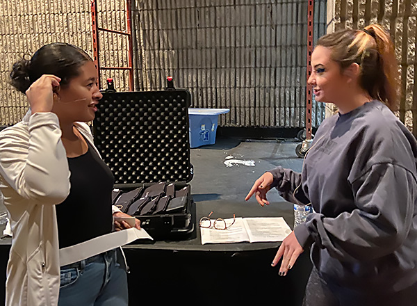 Kourtney Collins (right) discusses a scene with Emily Orellana (left) during a "Leo's Big Day Out" rehearsal. 