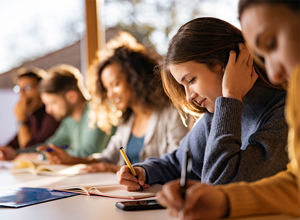 Students taking notes and studying. 