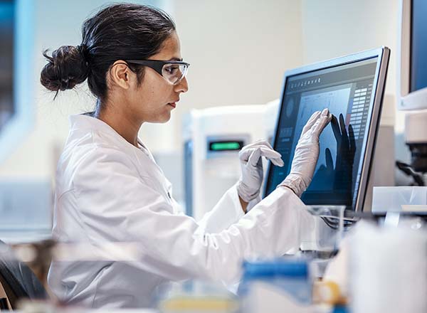 A woman sitting at a computer in a lab.