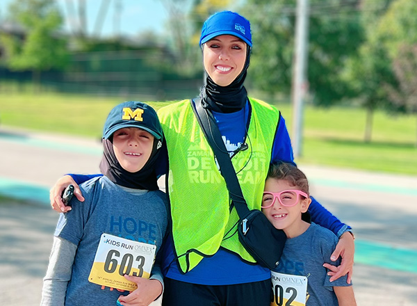 Dr. Fadia Cudry hugging her children, ready to join the annual Zaman Hope for Humanity Run Walk Picnic.