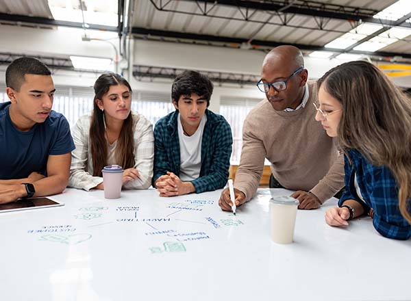 A teacher working with a group of students.