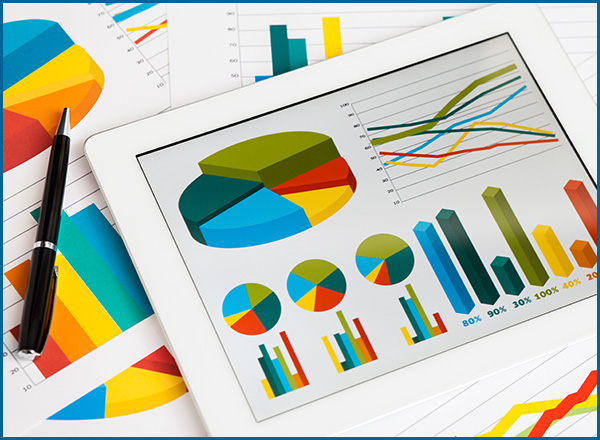 Digital tablet and business graphs.