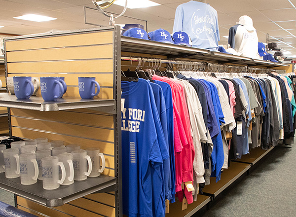 An aisle full of HFC shirts and mugs inside the College Store.