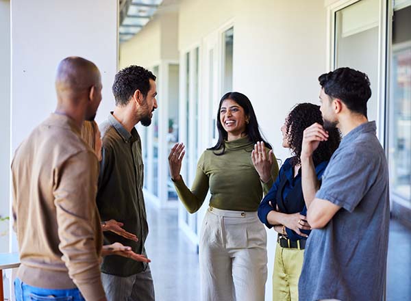 A female talking to a group of people.