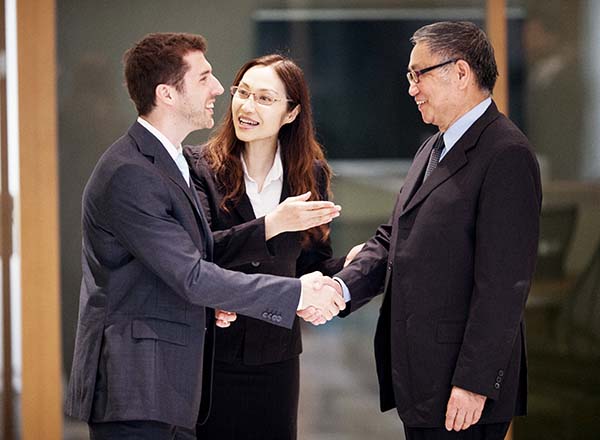 A woman interpreting between two men.