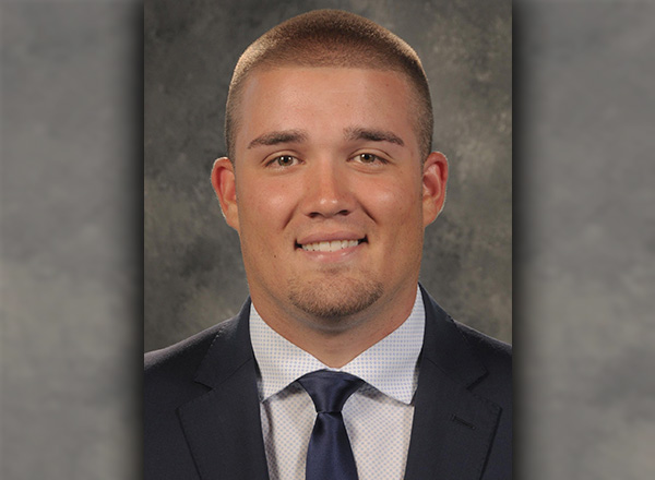 Headshot of Jack Pacholski wearing a suit and tie.